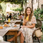 Woman in a floral midi dress at an outdoor brunch café table